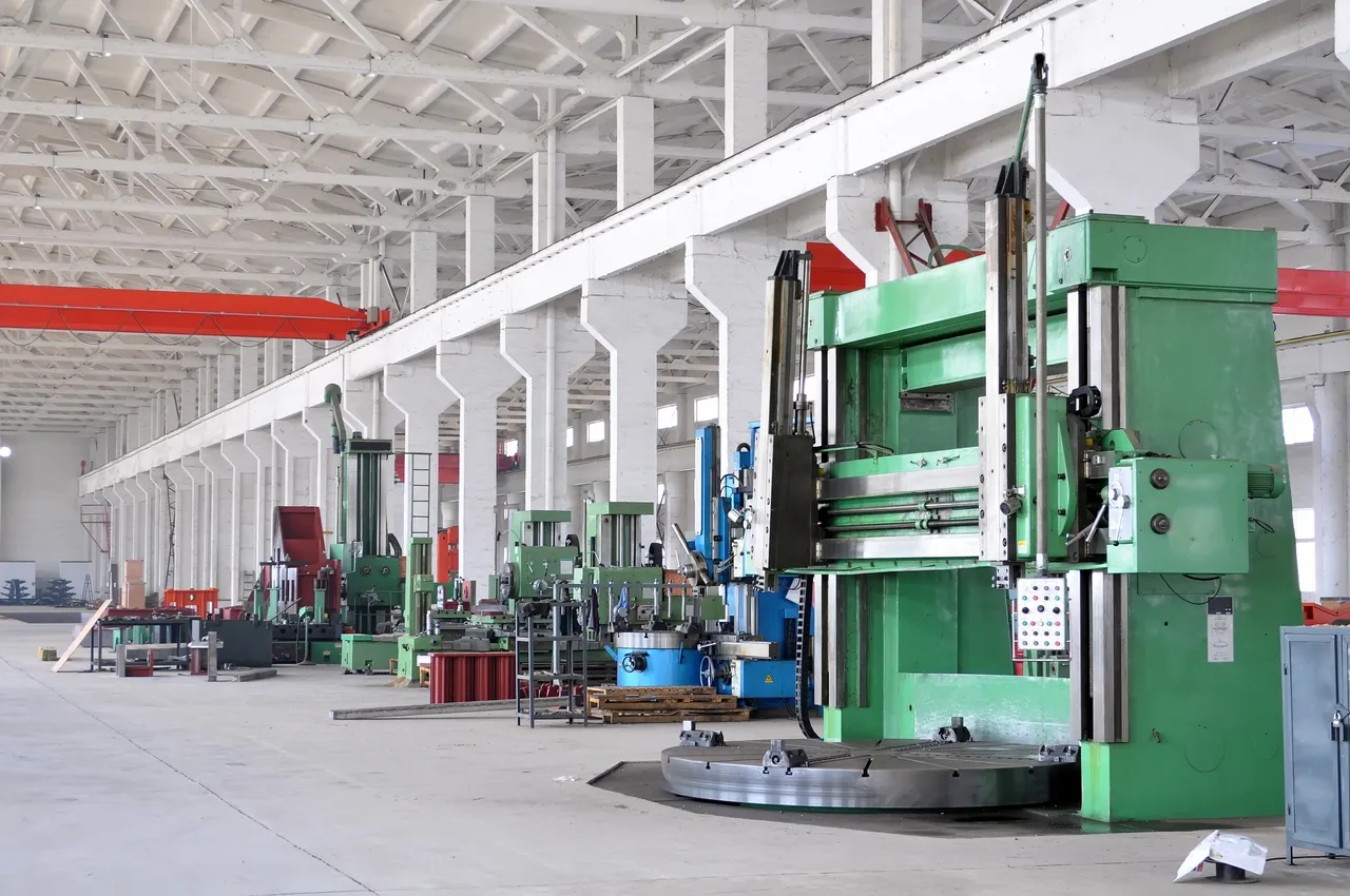 Industrial factory interior with green machines