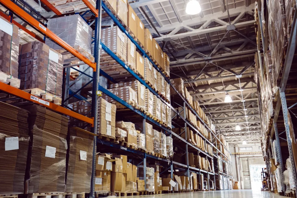 Warehouse aisle with stacked boxes on shelves